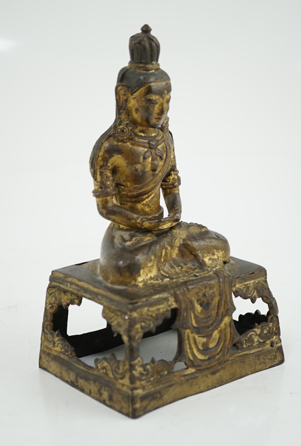 A Sino-Tibetan gilt repoussé copper alloy seated figure of Amitayus, Qianlong period, lacking aureole